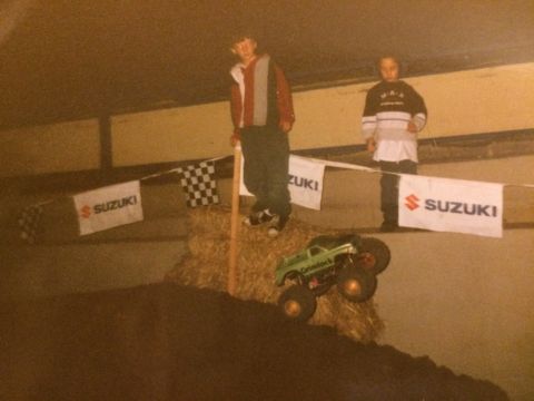 1989 Ford Bronco - A toy monster truck is seen in a display setting with several signs in the background.