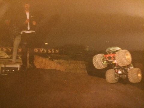 1989 Ford Bronco - An off-road vehicle with large tires is parked on a dirt surface during sunset.