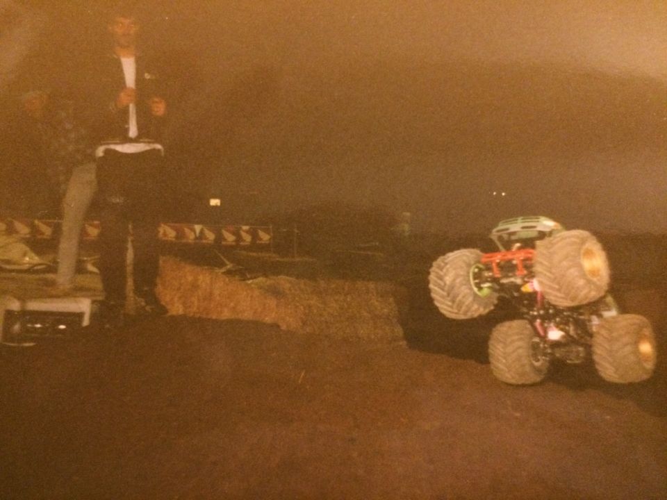 Off-road vehicle with large tires parked on dirt