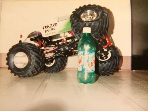 1989 Ford Bronco - A remote control monster truck with "CRAZED RACING" written on its side sits beside a bottle of Mountain Dew.