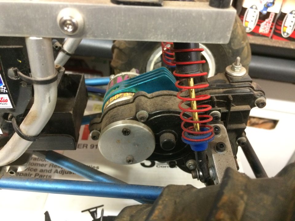 RC car motor and suspension assembly with red springs.