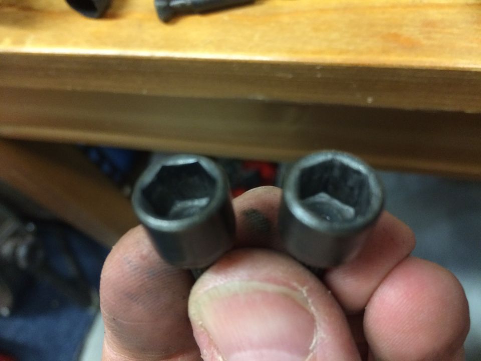 Two hex sockets held in a hand.