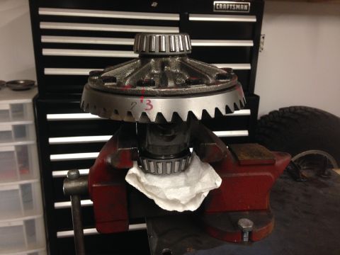 1979 Ford Bronco - Differential gear assembly being worked on, with a toolbox and tire visible in the background.