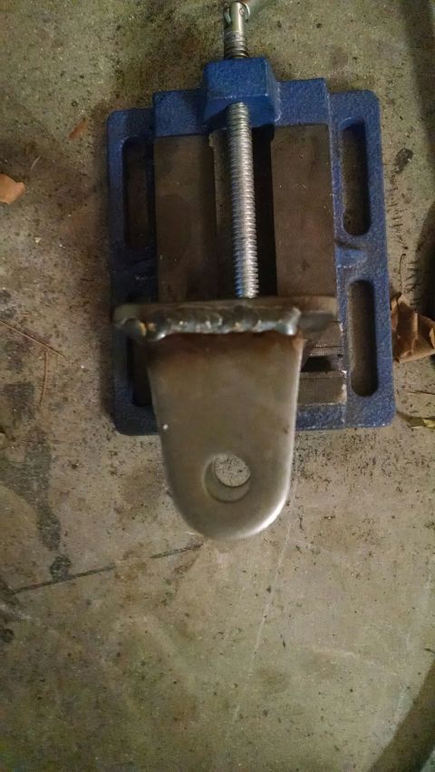 1979 Ford Bronco - A metal component is secured in a vise, ready for modification or repair.