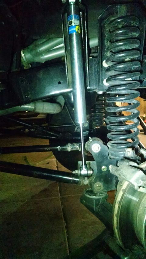 1979 Ford Bronco - The rear suspension system of a vehicle, a shock absorber and coil spring, is visible.