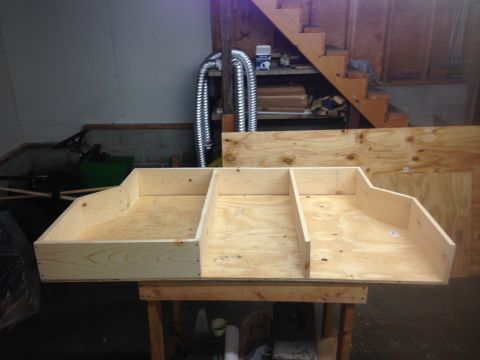 1979 Ford Bronco - Unfinished plywood storage box with three compartments, likely for a vehicle's cargo area.