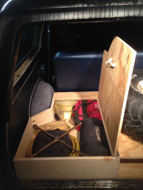 1979 Ford Bronco - Custom wooden storage box in the rear of a 1979 Ford Bronco, holding gear and a spare tire.