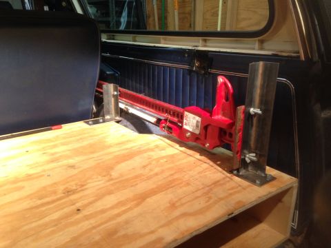 1979 Ford Bronco - Custom storage platform with hi-lift jack installed in the rear of a vehicle.