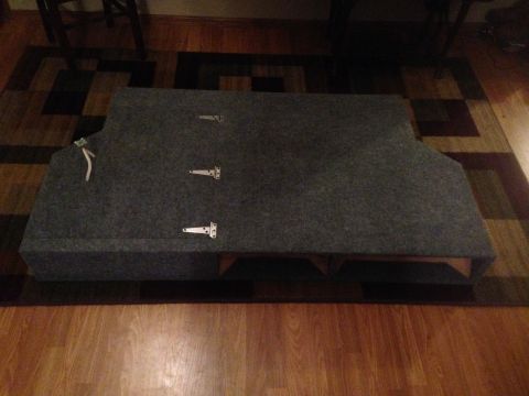 1979 Ford Bronco - A carpeted storage box with three visible hinges and a rope pull is shown on a rug.