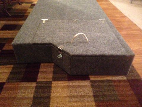 1979 Ford Bronco - Storage box with rope handle and metal latches sits on a checkered rug.