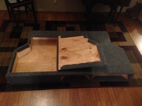 1979 Ford Bronco - This custom-built storage box appears to be made of wood and carpet, with a hinged wooden lid.