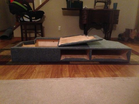 1979 Ford Bronco - A custom-made storage box with multiple compartments and a wooden lid is shown on a wooden floor.