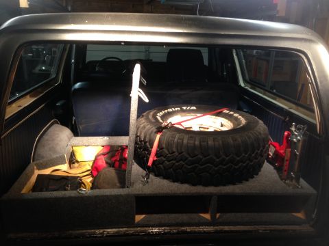 1979 Ford Bronco - Custom storage unit in the rear of a 1979 Ford Bronco holds a spare tire and jack.