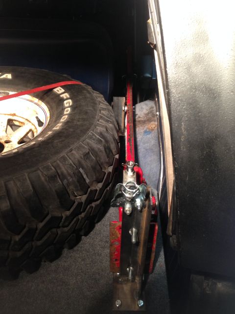 1979 Ford Bronco - Spare tire and jack mechanism visible in the cargo area of a vehicle.