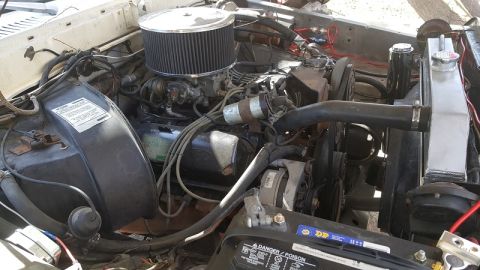 1978 Ford Bronco - Engine bay view showing the V8 engine, air filter, radiator, and battery.