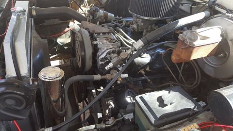 1978 Ford Bronco - The engine bay of a 1978 Ford Bronco shows an aftermarket radiator and various engine components.