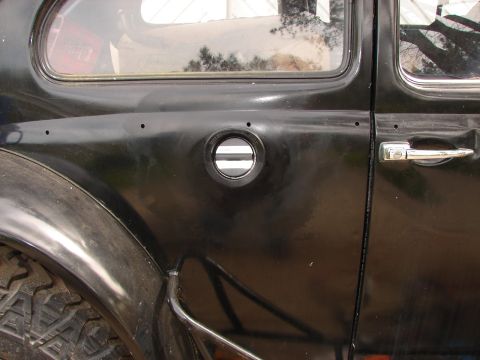 1964 Volkswagen Beetle - Close-up of the fuel door on a 1964 Volkswagen Beetle.
