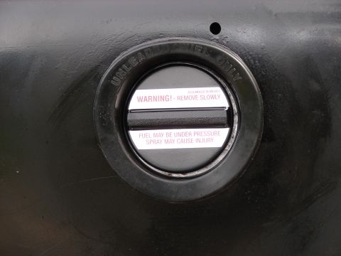1964 Volkswagen Beetle - This fuel filler cap has warnings about pressure and potential injury from fuel spray.