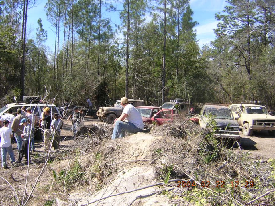 1984 Chevrolet Blazer in a wooded area with other off-road vehicles and people