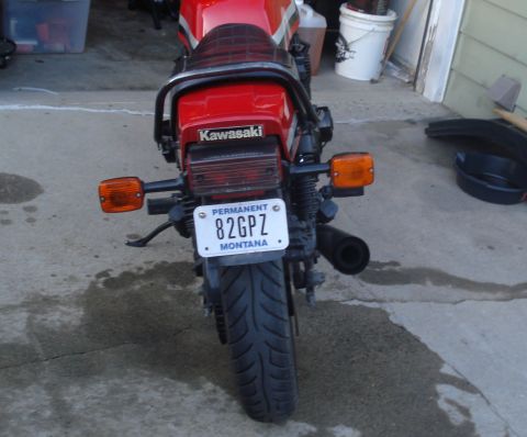 2008 Ford Crown Victoria - Rear view of a red Kawasaki motorcycle, displaying a Montana license plate.