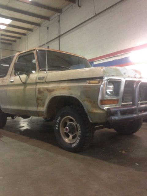 1978 Ford Bronco - This 1978 Ford Bronco shows significant rust and is parked inside a garage.