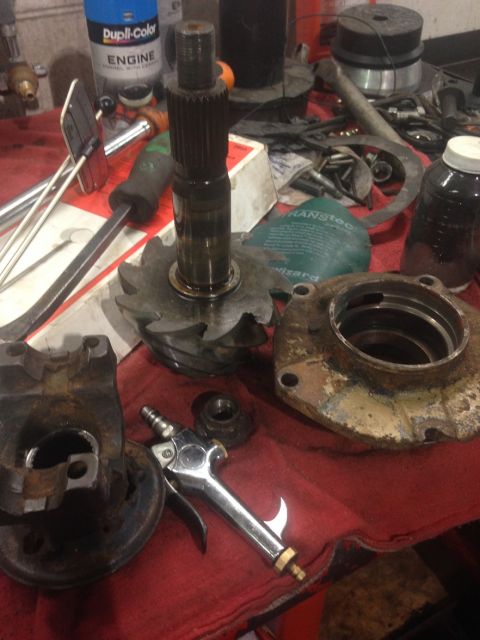 1978 Ford Bronco - Various automotive differential components are spread across a workbench, alongside tools and a can of Dupli-Color engine paint.