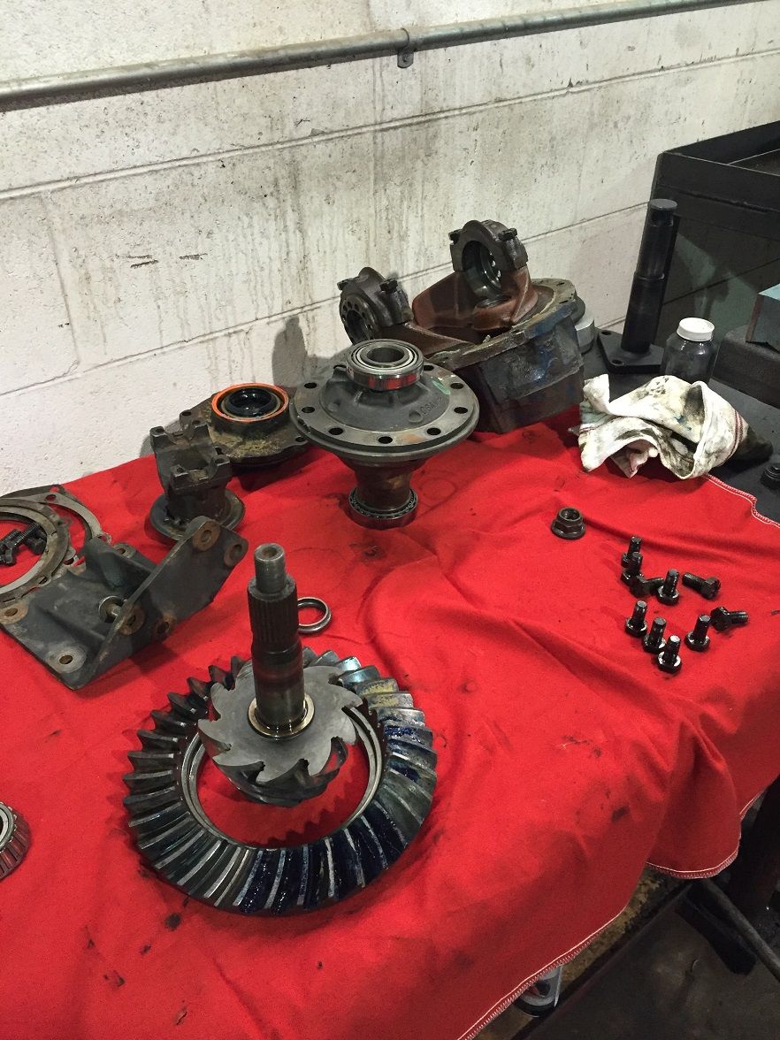 Differential gears and components laid out on a red cloth