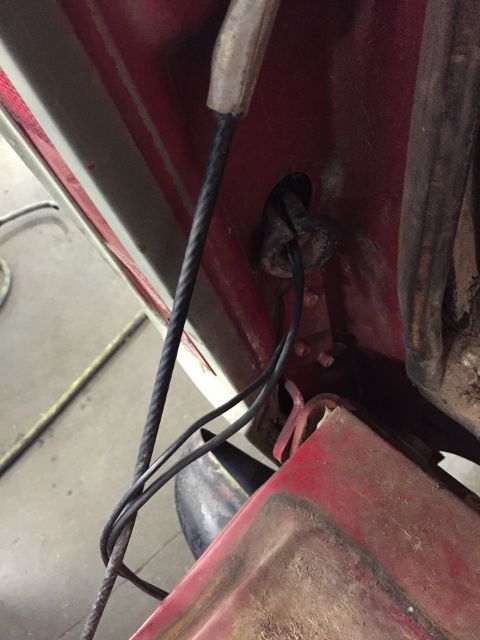 1978 Ford Bronco - Close-up view of a vehicle's interior wiring and latch mechanism, with a watermark present.
