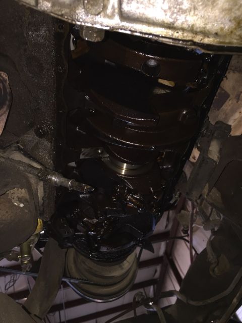 1978 Ford Bronco - Close-up view of a heavily sludged engine oil pan, indicating potential maintenance issues.