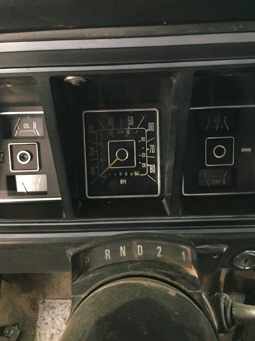Dashboard gauges of a 1978 Ford Bronco, including speedometer, oil pressure, and temperature gauges