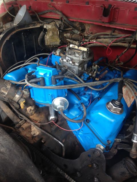 1978 Ford Bronco - The engine bay shows a blue painted engine with various components, including a carburetor and distributor.