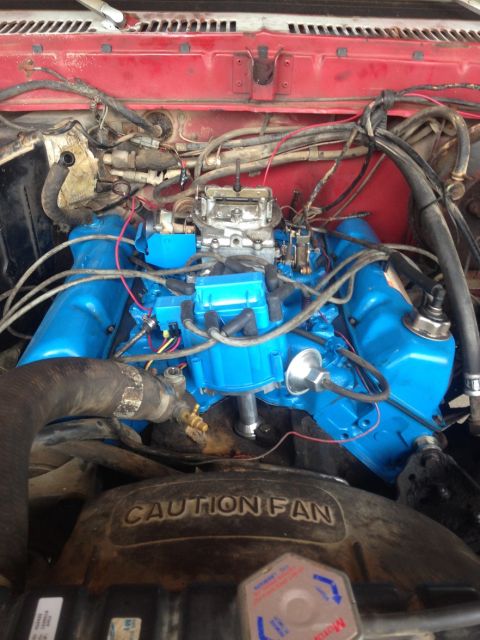 1978 Ford Bronco - Close-up view of a vehicle's engine bay, showing the carburetor and painted components.