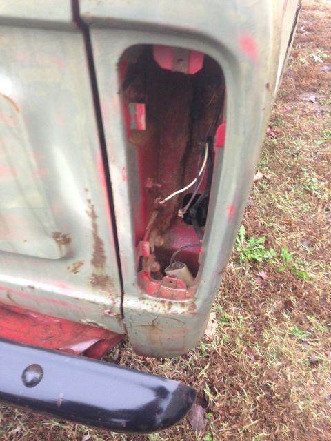 1978 Ford Bronco - The rear taillight housing is missing, revealing the internal wiring and mounting points of the vehicle.