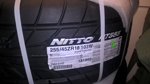2004 Ford Crown Victoria - New Nitto NT555 tire, size 255/45ZR18 103W, is shown in its packaging.