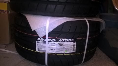 2004 Ford Crown Victoria - A pair of Nitto NT555 tires are stacked and secured with protective wrapping and straps.