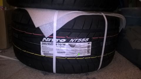 2004 Ford Crown Victoria - New Nitto NT555 tires are shown stacked and secured with white straps.