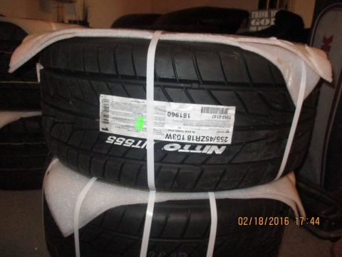 2004 Ford Crown Victoria - Nitto NT555 tires stacked and wrapped for storage or transport.