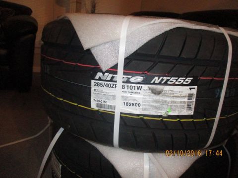 2004 Ford Crown Victoria - Close-up of new Nitto NT555 tires, showing size and model information on the labels.