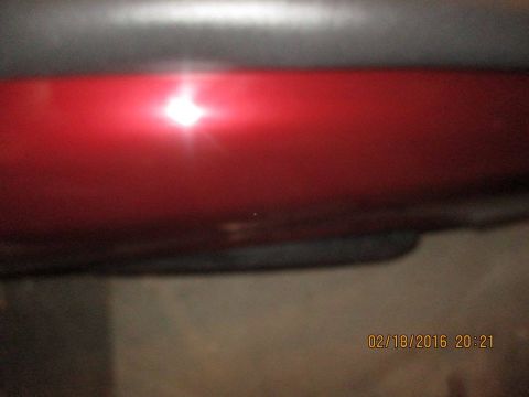 2004 Ford Crown Victoria - A close-up of a red car panel with a date stamp of 02/18/2016.