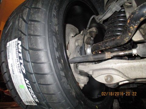 2004 Ford Crown Victoria - Close-up of a Nitto NT555 tire and part of the vehicle's suspension system.