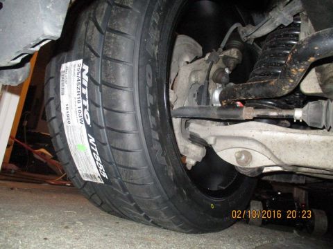2004 Ford Crown Victoria - Close-up of a new tire and suspension components, dated February 18, 2016.
