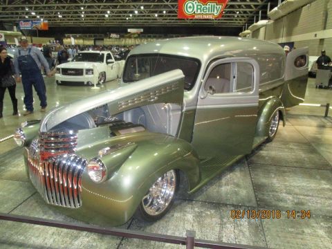 2004 Ford Crown Victoria - A custom panel van is displayed with its hood open, its custom grille and wheels.
