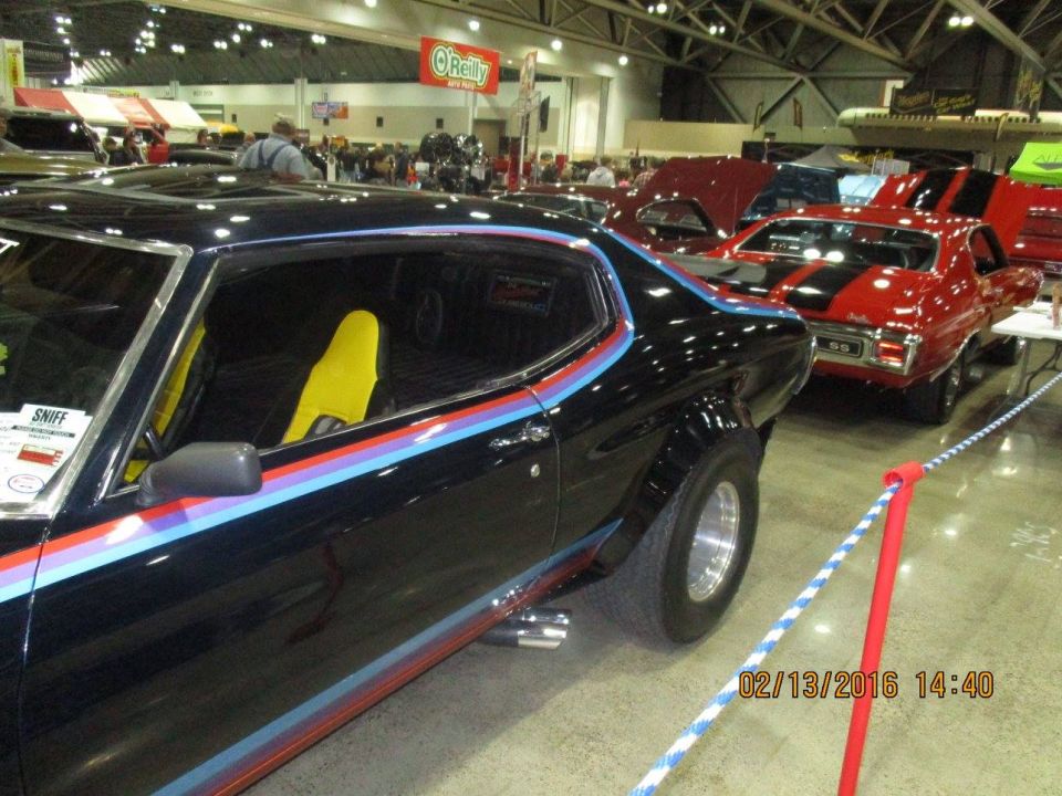 Black muscle car with tri-color stripes and yellow racing seats