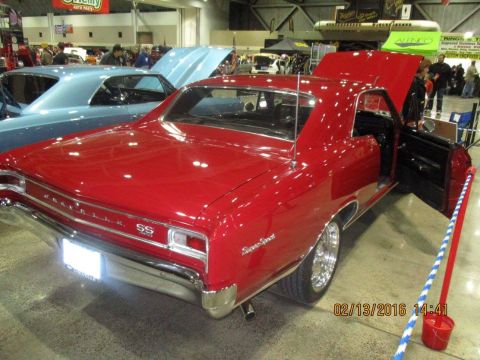 2004 Ford Crown Victoria - A classic red Chevrolet SS is displayed with its doors and hood open at an indoor event.