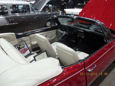 2004 Ford Crown Victoria - The interior of a red convertible is shown, with a sign indicating 'Custom and Factory Original' upholstery.