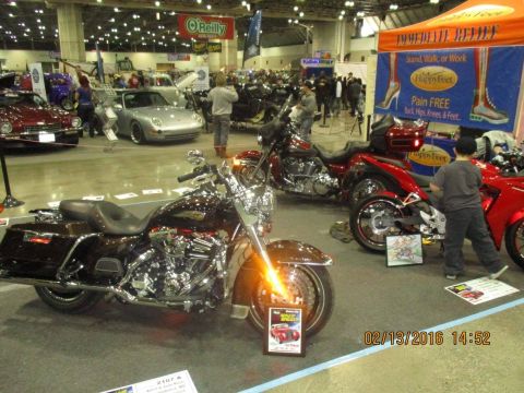 2004 Ford Crown Victoria - Motorcycles are displayed indoors at an event, with a young boy observing one of the bikes.