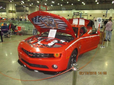 2004 Ford Crown Victoria - A red Chevrolet Camaro is displayed with its hood and door open, revealing a custom American flag decal.
