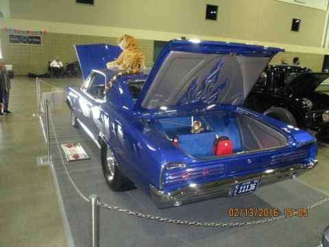 2004 Ford Crown Victoria - Custom blue car on display with its trunk and hood open, next to another vehicle.