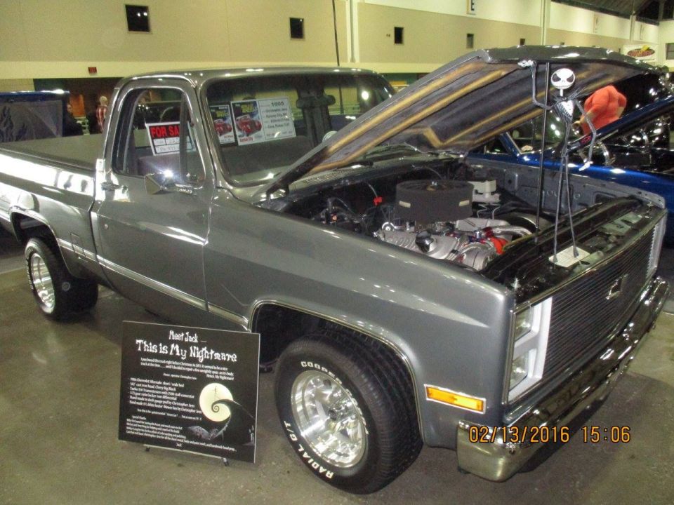 Gray pickup truck with hood open, showing engine and a sign titled 'Meet Jack This Is My Nightmare'