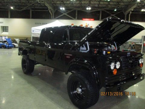2004 Ford Crown Victoria - A black Dodge pickup truck is displayed with its hood open, showing the engine compartment.
